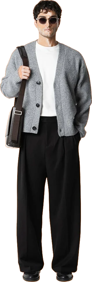 A grey cardigan over a white tee with black wide-leg trousers